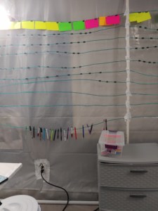 image of office wall with notecards and pens